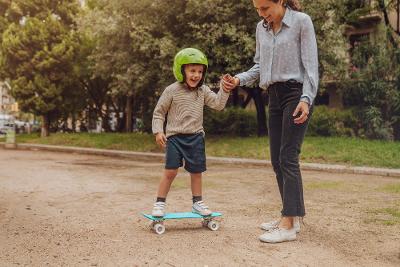 Boy skateboarding with foster parent