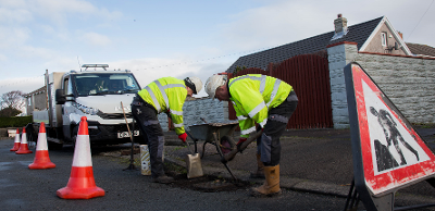 Highways staff fixing a pothole
