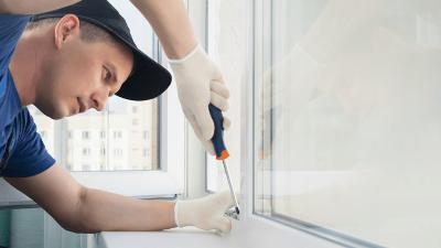 Contractor fixing a window