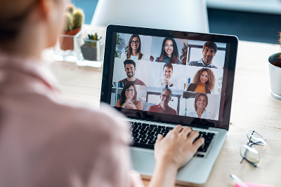 Woman using a laptop for a group meeting