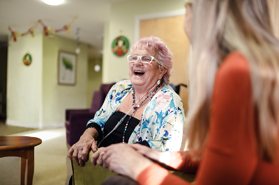 Lady laughing with a carer